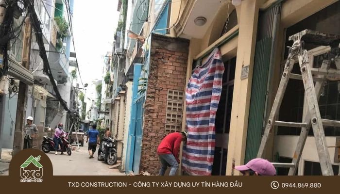 Gia đình đang thảo luận bản vẽ thiết kế, cân nhắc các lưu ý quan trọng khi xây nhà trong ngõ hẹp